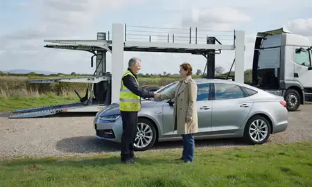 Vehicle owner beside their delivered car in Bedfordshire, United Kingdom