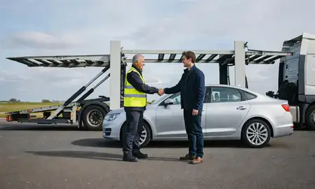 Vehicle owner beside their delivered car in Luton, Bedfordshire, United Kingdom