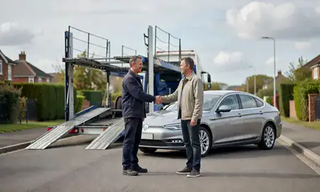 Vehicle owner beside their delivered car in Newbury, Berkshire, United Kingdom
