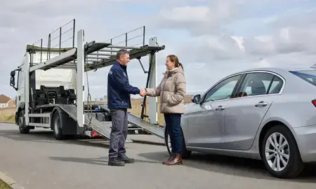 Vehicle owner beside their delivered car in Slough, Berkshire, United Kingdom