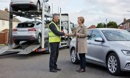 Vehicle owner beside their delivered car in Woodley, Berkshire, United Kingdom