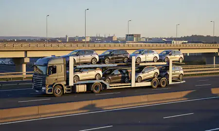 Car transporter with the Bristol, United Kingdom skyline behind it