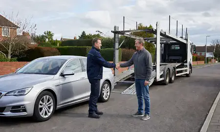Vehicle owner beside their delivered car in Aylesbury, Buckinghamshire, United Kingdom
