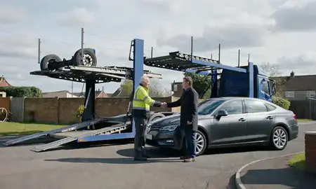 Vehicle owner beside their delivered car in Bletchley, Buckinghamshire, United Kingdom