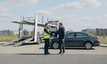 Vehicle owner beside their delivered car in Milton Keynes, Buckinghamshire, United Kingdom
