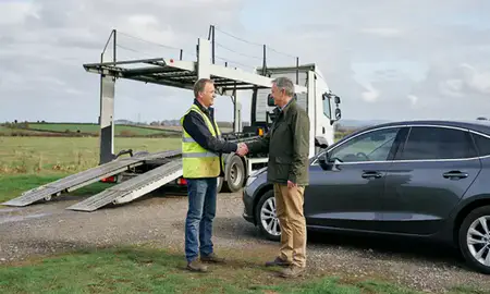 Vehicle owner beside their delivered car in Cambridgeshire, United Kingdom