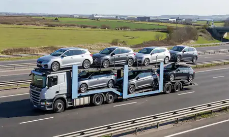 Multi-level car carrier on the motorway to Ellesmere Port, Cheshire, United Kingdom