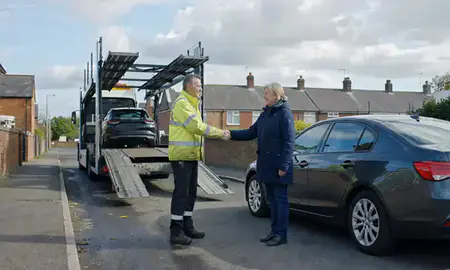Vehicle owner beside their delivered car in Northwich, Cheshire, United Kingdom