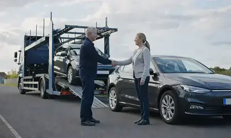 Vehicle owner beside their delivered car in Warrington, Cheshire, United Kingdom