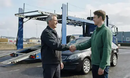 Vehicle owner beside their delivered car in Belfast, County Antrim, United Kingdom