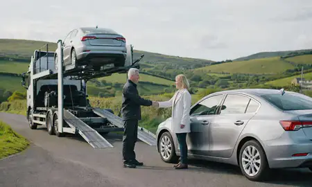 Vehicle owner beside their delivered car in County Down, United Kingdom
