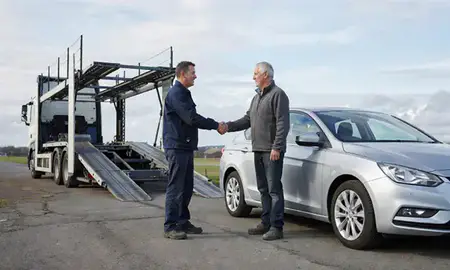 Vehicle owner beside their delivered car in Stockton-on-Tees, County Durham, United Kingdom