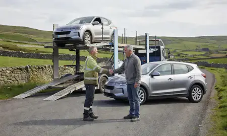Vehicle owner beside their delivered car in Cumbria, United Kingdom