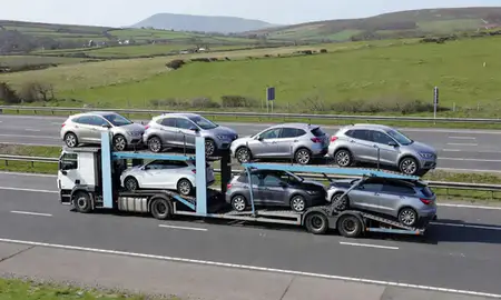 Multi-level car carrier on the motorway to Barrow-in-Furness, Cumbria, United Kingdom