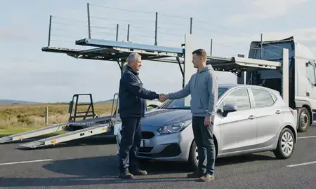 Vehicle owner beside their delivered car in Barrow-in-Furness, Cumbria, United Kingdom