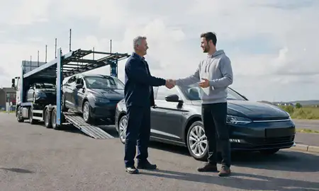 Vehicle owner beside their delivered car in Carlisle, Cumbria, United Kingdom
