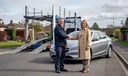 Vehicle owner beside their delivered car in Derby, Derbyshire, United Kingdom
