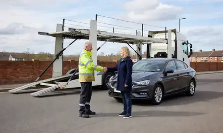 Vehicle owner beside their delivered car in Swadlincote, Derbyshire, United Kingdom
