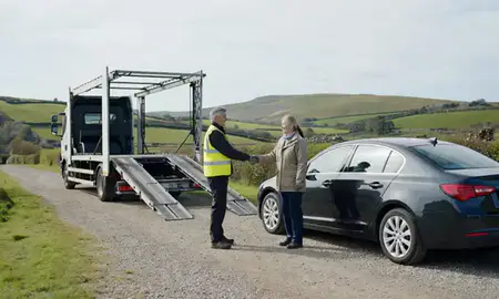 Vehicle owner beside their delivered car in Devon, United Kingdom
