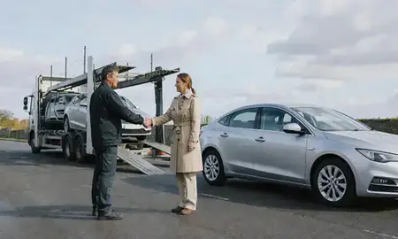 Vehicle owner beside their delivered car in Exeter, Devon, United Kingdom