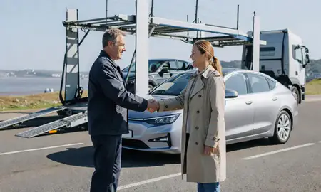 Vehicle owner beside their delivered car in Exmouth, Devon, United Kingdom