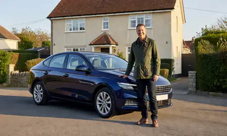 Customer with their delivered car in Paignton, Devon, United Kingdom