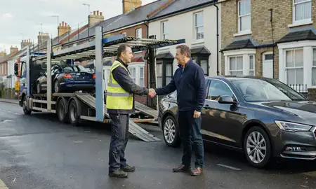 Vehicle owner beside their delivered car in Plymouth, Devon, United Kingdom