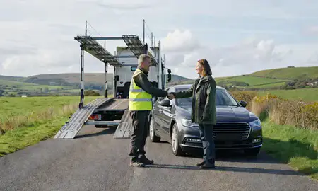 Vehicle owner beside their delivered car in Dorset, United Kingdom