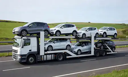 Multi-level car carrier on the motorway to Bournemouth, Dorset, United Kingdom