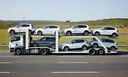 Multi-level car carrier on the motorway to Poole, Dorset, United Kingdom