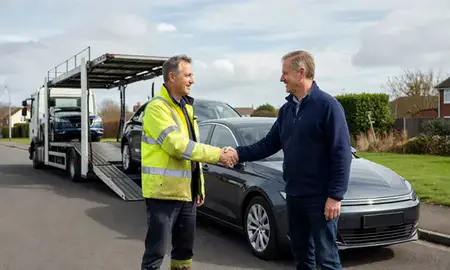 Vehicle owner beside their delivered car in Poole, Dorset, United Kingdom