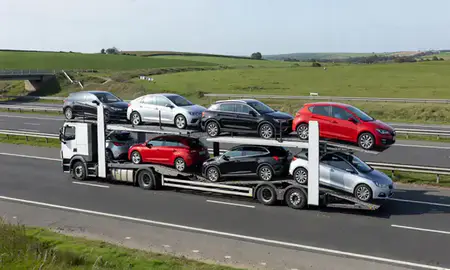 Multi-level car carrier on the motorway to Weymouth, Dorset, United Kingdom