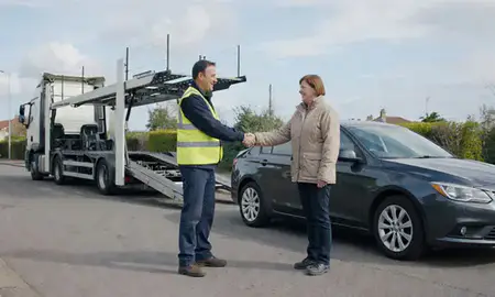 Vehicle owner beside their delivered car in Weymouth, Dorset, United Kingdom