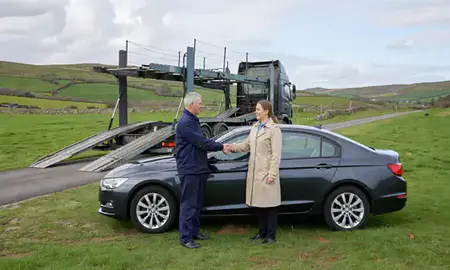 Vehicle owner beside their delivered car in Dyfed, United Kingdom