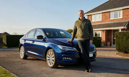 Customer with their delivered car in Llanelli, Dyfed, United Kingdom