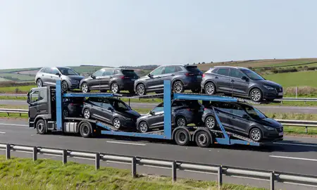 Multi-level car carrier on the motorway to Bexhill-on-Sea, East Sussex, United Kingdom