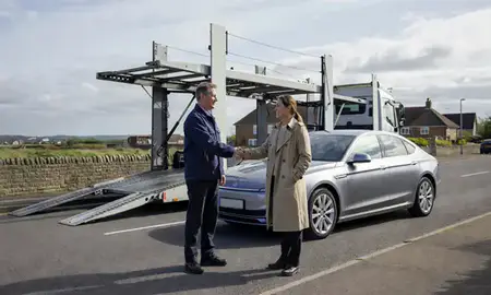 Vehicle owner beside their delivered car in Bexhill-on-Sea, East Sussex, United Kingdom