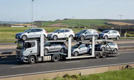 Multi-level car carrier on the motorway to Brighton, East Sussex, United Kingdom