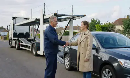 Vehicle owner beside their delivered car in Brighton, East Sussex, United Kingdom