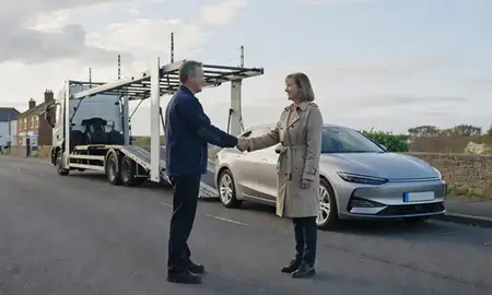 Vehicle owner beside their delivered car in Eastbourne, East Sussex, United Kingdom