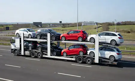Multi-level car carrier on the motorway to Grays, Essex, United Kingdom