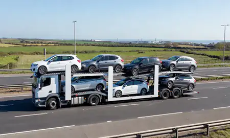 Multi-level car carrier on the motorway to Southend-on-Sea, Essex, United Kingdom