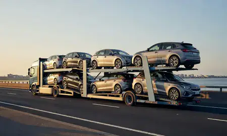 Car transporter with the Southend-on-Sea, Essex, United Kingdom skyline behind it
