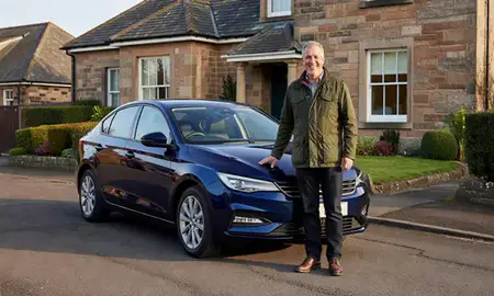 Customer with their delivered car in Glasgow, United Kingdom