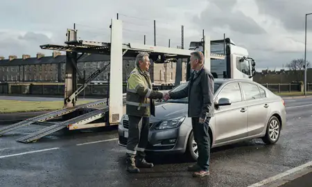 Vehicle owner beside their delivered car in Glasgow, United Kingdom