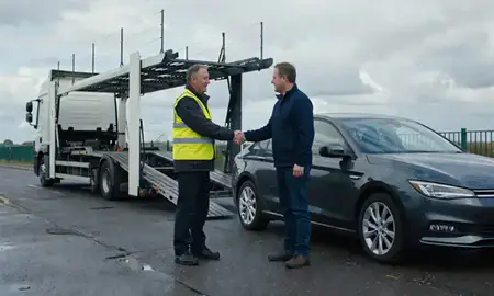 Vehicle owner beside their delivered car in Greater Manchester, United Kingdom
