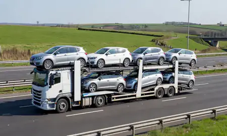 Multi-level car carrier on the motorway to Altrincham, Greater Manchester, United Kingdom
