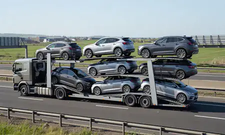 Multi-level car carrier on the motorway to Ashton-under-Lyne, Greater Manchester, United Kingdom