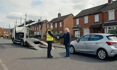 Vehicle owner beside their delivered car in Ashton-under-Lyne, Greater Manchester, United Kingdom