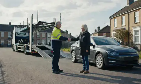 Vehicle owner beside their delivered car in Atherton, Greater Manchester, United Kingdom